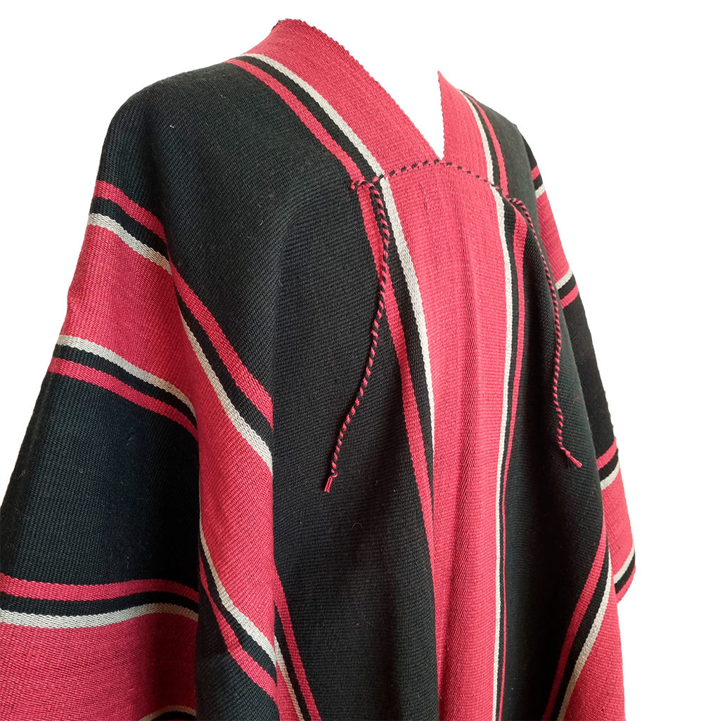 Close-up of Atuel Listado poncho with red, black and natural stripe details