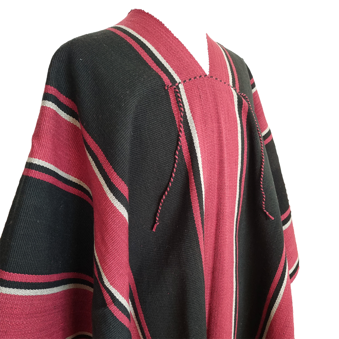 Close-up of Atuel Listado poncho with red, black and natural stripe details