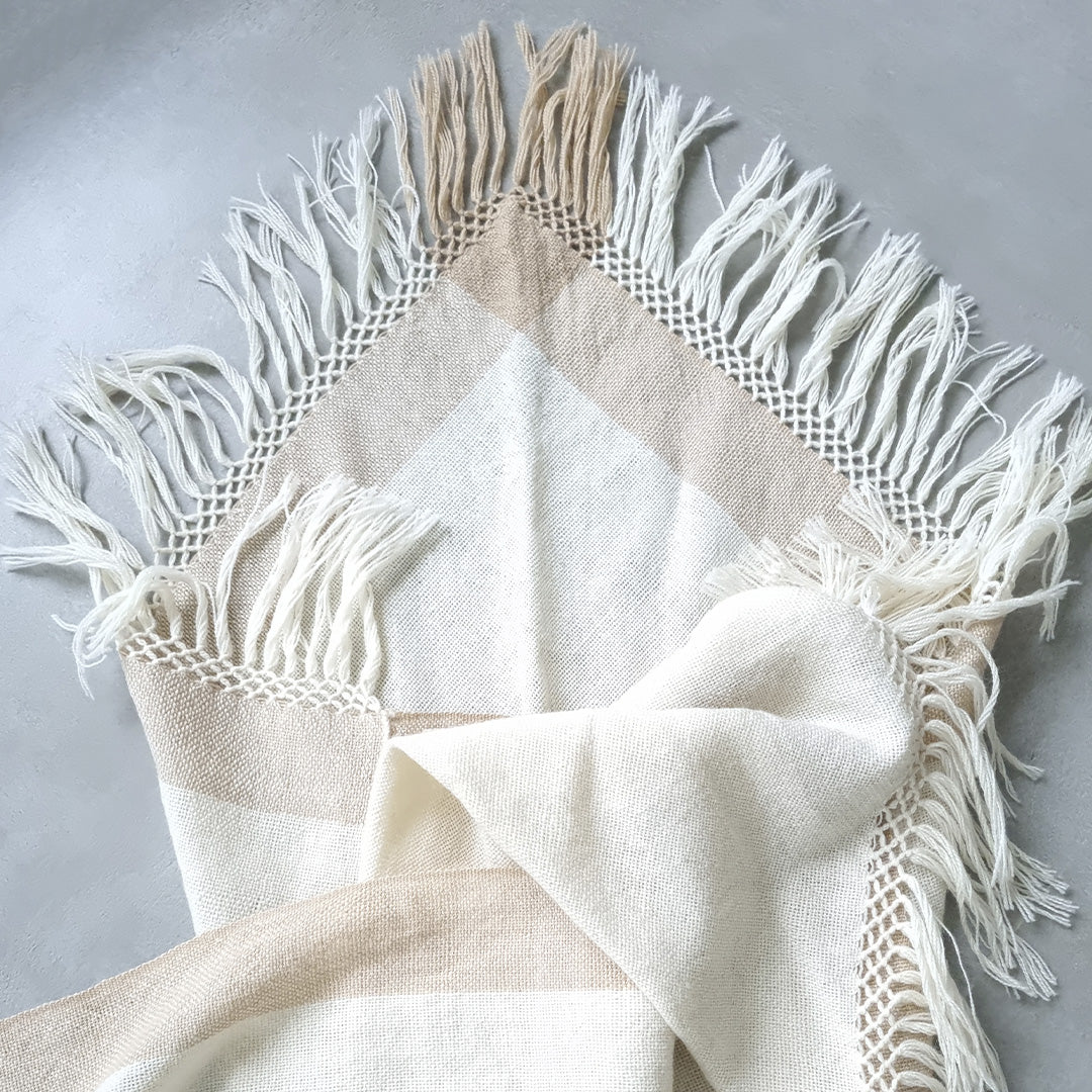 Cream sheep wool ruana with wide beige stripe and fringed edges