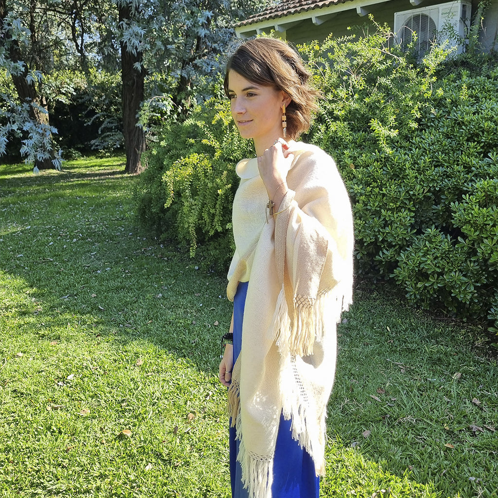 Neutral wool ruana wrap worn outdoors over the shoulders