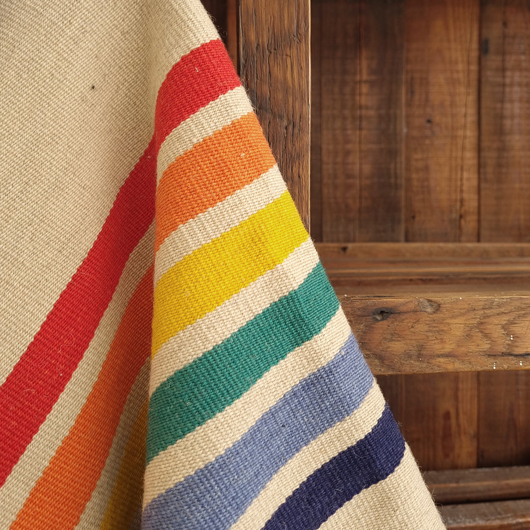 Rainbow stripe detail on artisan poncho inspired by unity and pride