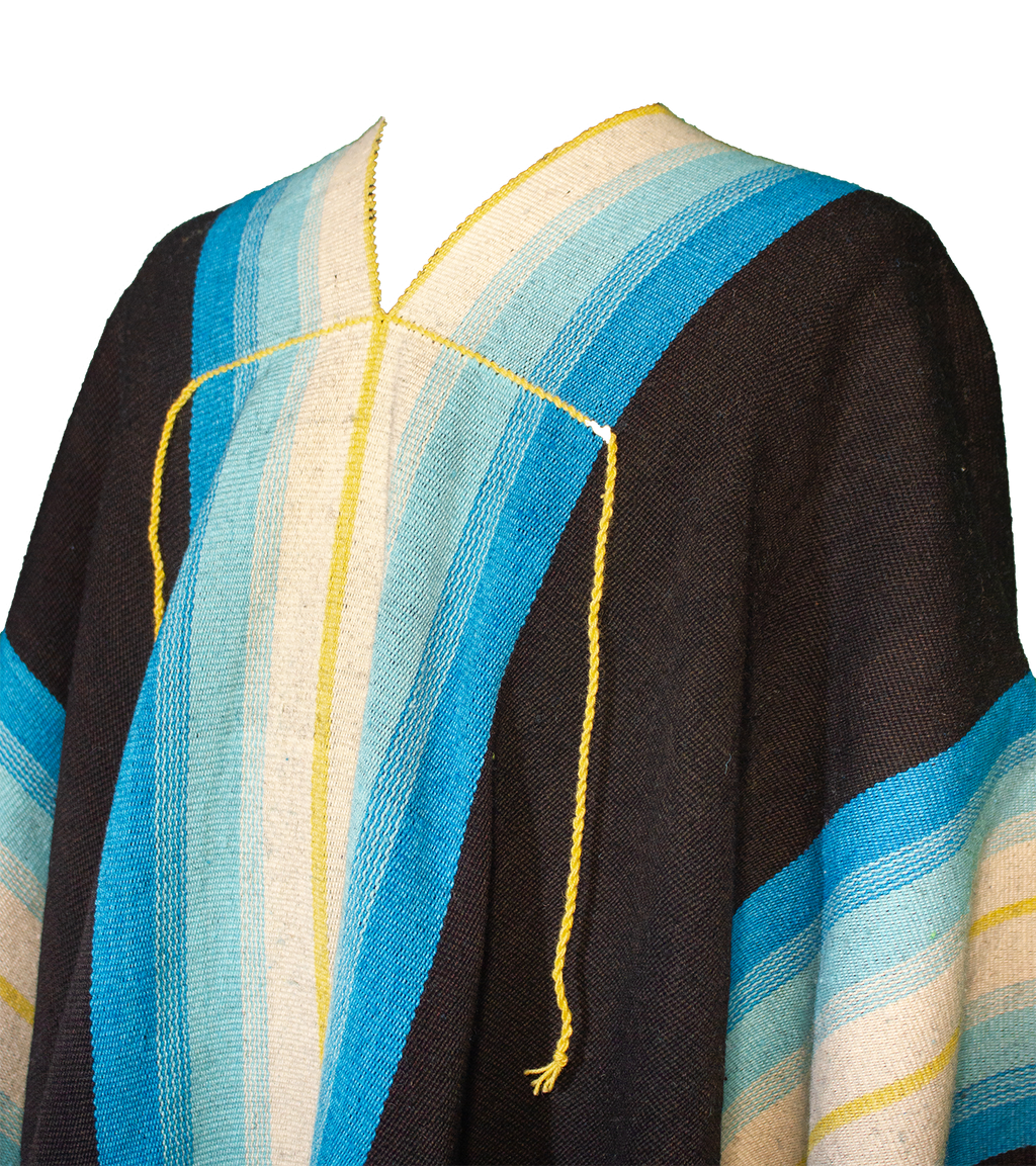 Close-up of Molinos Listado poncho with turquoise, cream and yellow stripe details